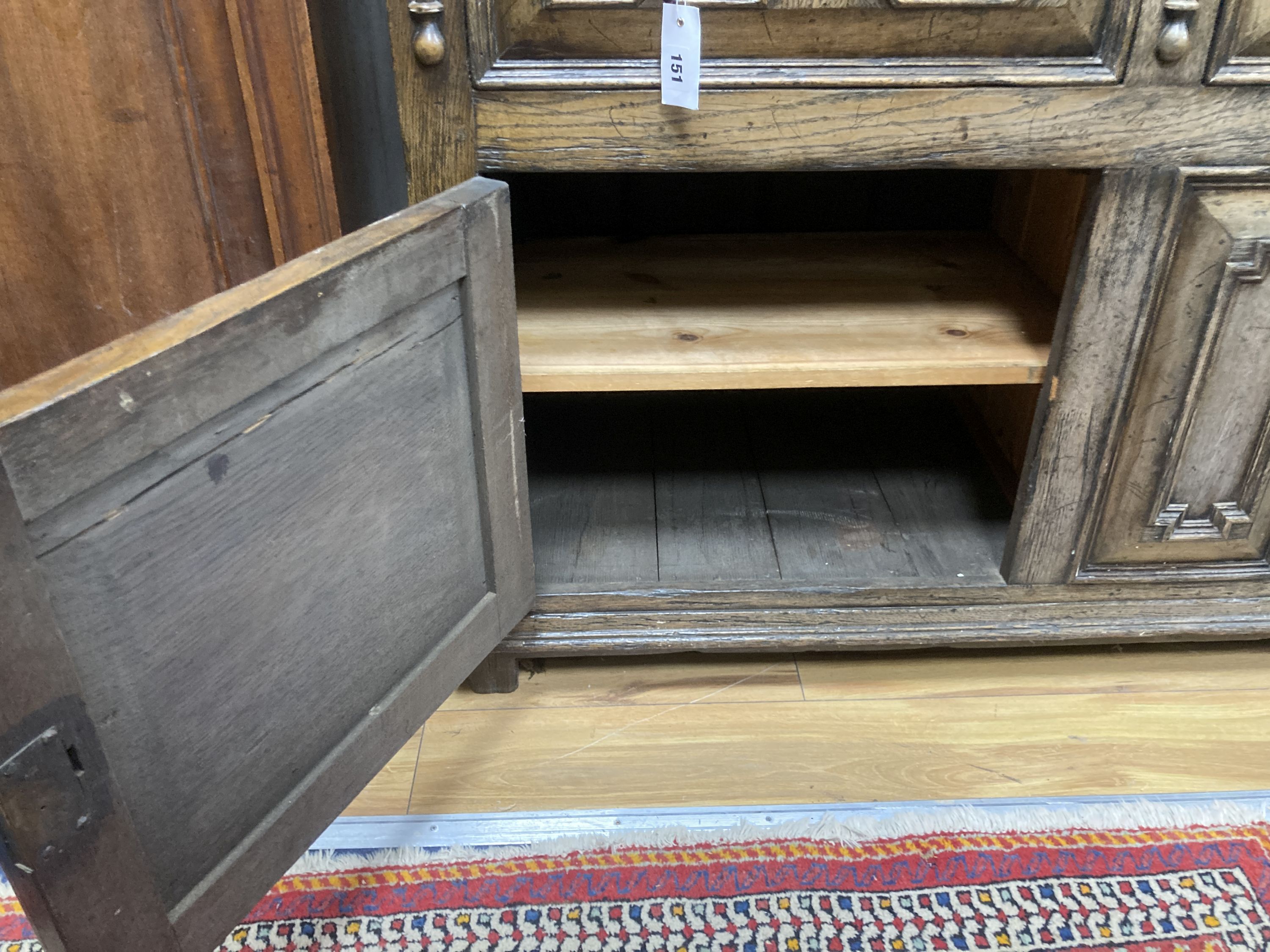 An early 20th century Jacobean style oak dresser, width 150cm, depth 47cm, height 199cm